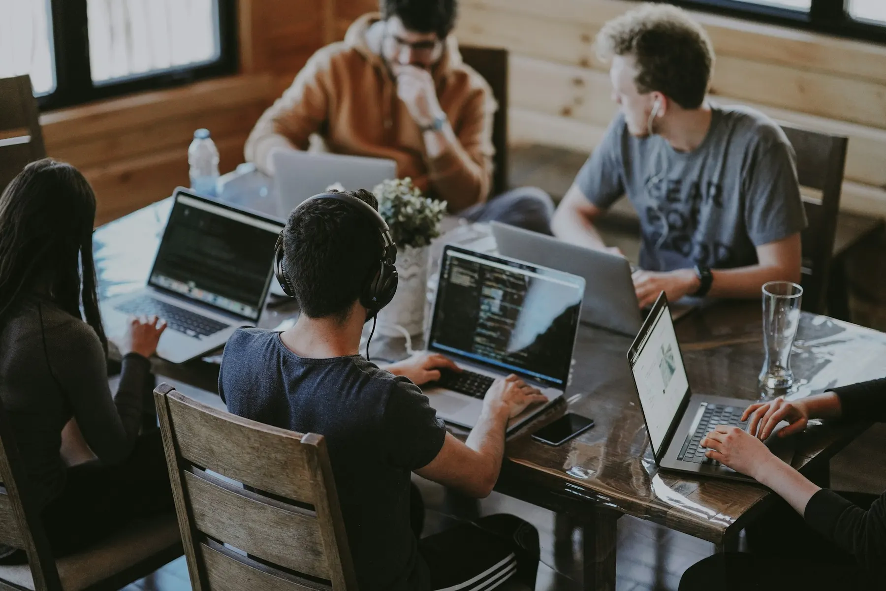 A team working together on laptops around one table