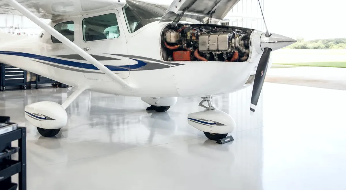 A club aircraft back in the hangar with the cowling open
